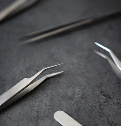 Zbliżenie pęsety do rzęs